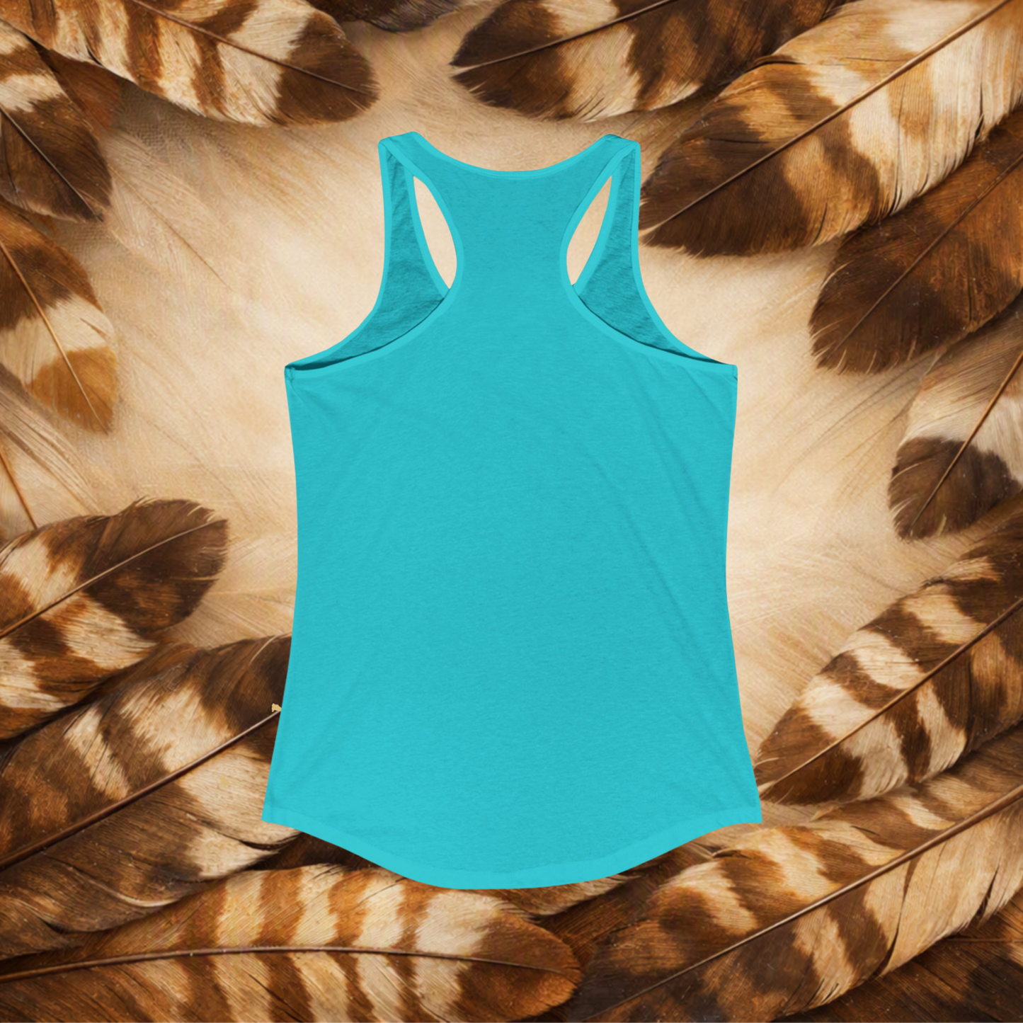 Solid Tahiti Blue backview of a flat lay racerback tank top on a background of brown and cream feathers.