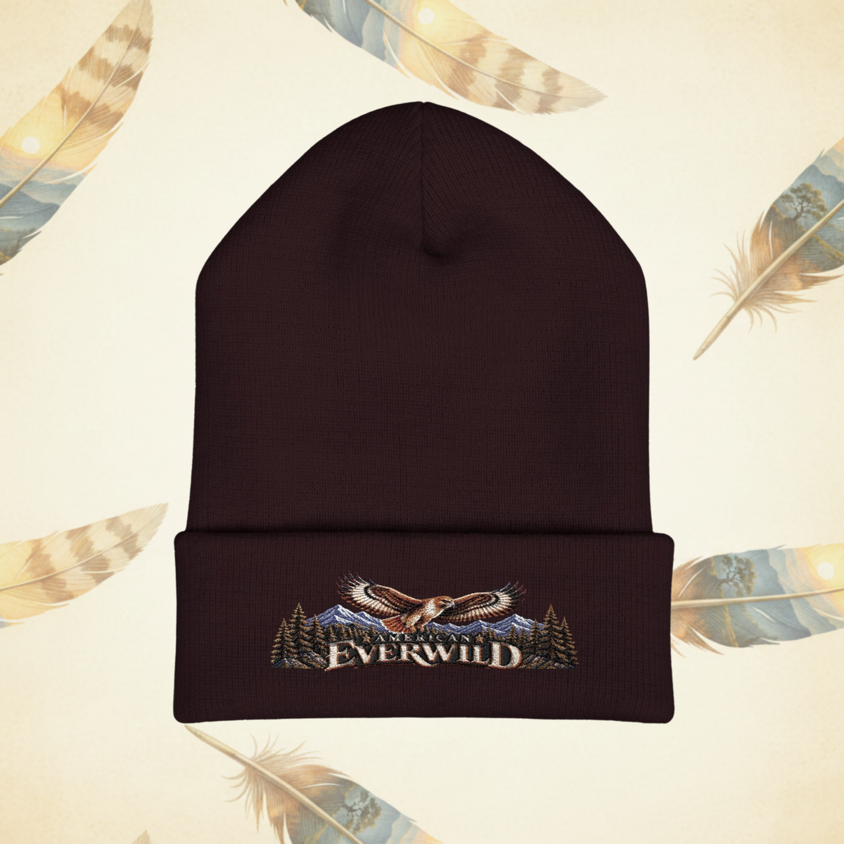 Brown American EverWild Beanie flat-lay on a cream-colored background of painted feathers.