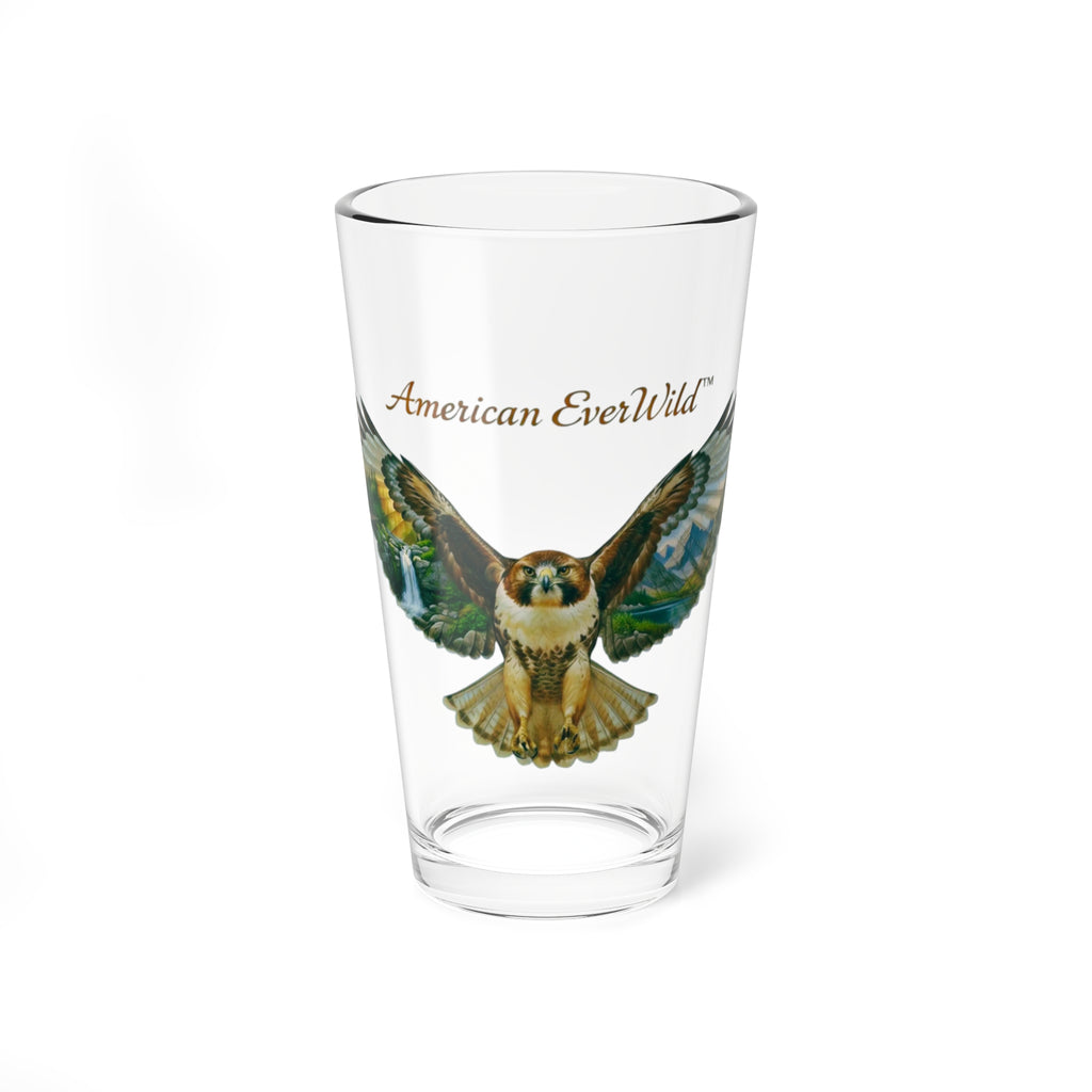 A clear pint glass featuring a printed illustration of a re-tailed hawk with spread wings and the text 'American EverWild' in brown script, shown on a plain white background.