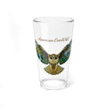 A clear pint glass featuring a printed illustration of a re-tailed hawk with spread wings and the text 'American EverWild' in brown script, shown on a plain white background.