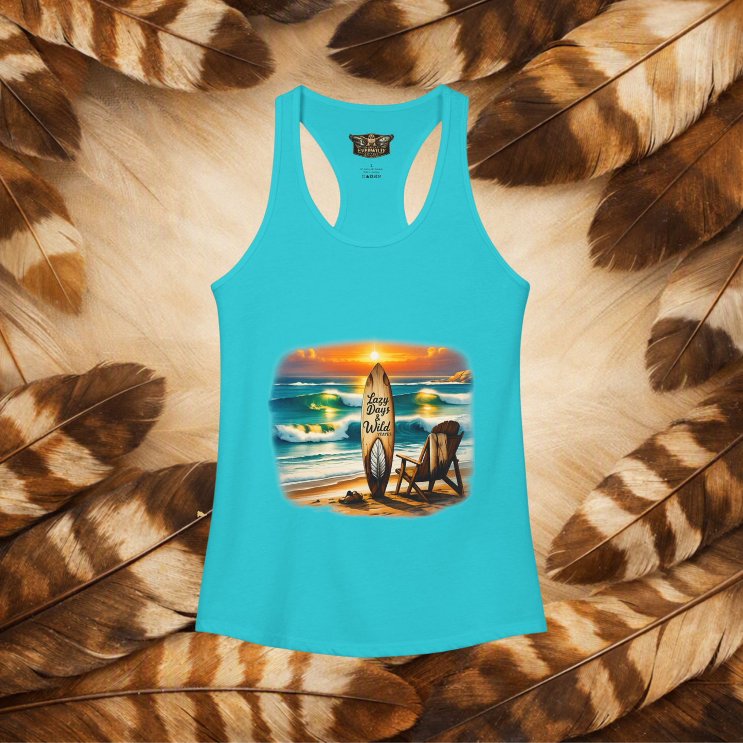 Solid Tahiti Blue front view of a flat lay racerback tank top with a graphic beach scene, chair and surfboard that has the text "Lazy Days & Wild Waves" on a background of brown and cream feathers.