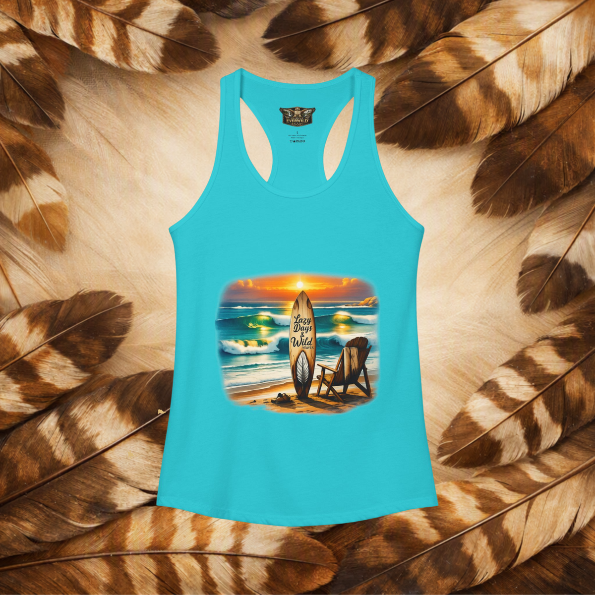 Solid Tahiti Blue front view of a flat lay racerback tank top with a graphic beach scene, chair and surfboard that has the text "Lazy Days & Wild Waves" on a background of brown and cream feathers.
