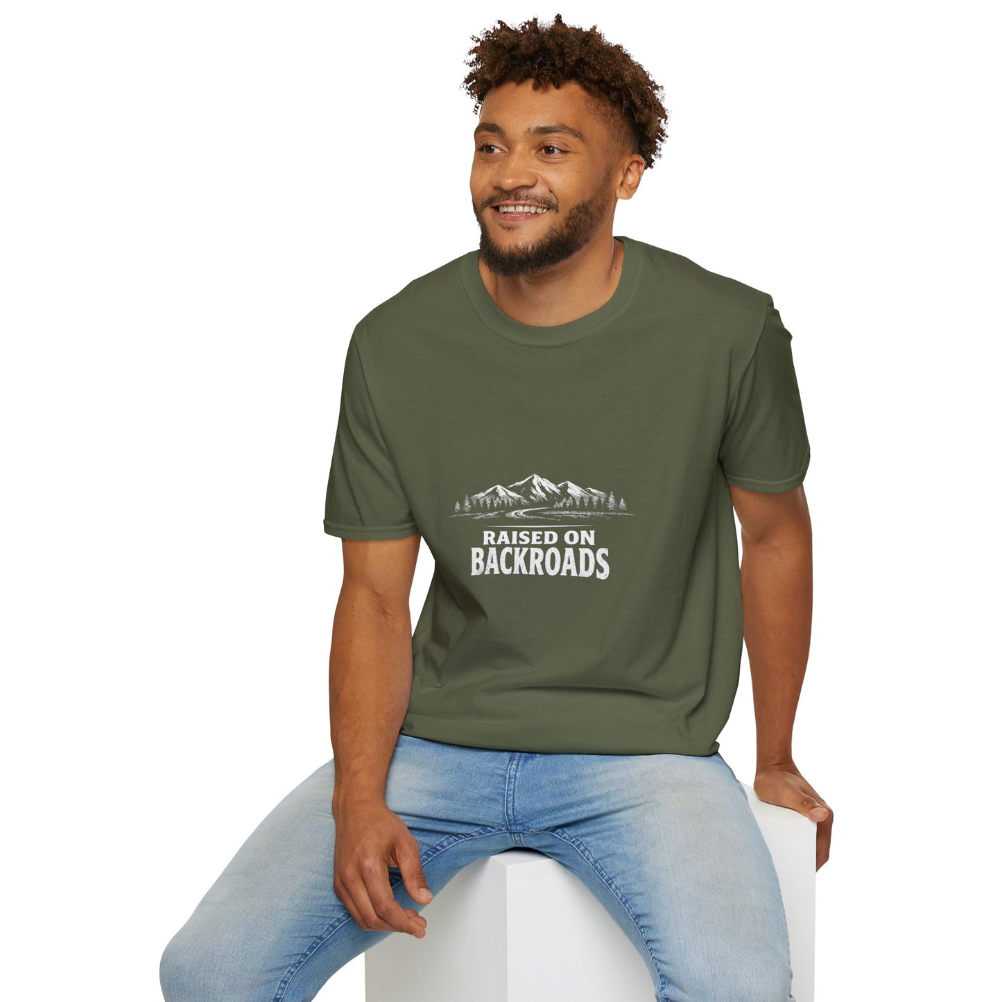 Military green crewneck T-shirt worn with front mountain landscape and “Raised on Backroads” text.