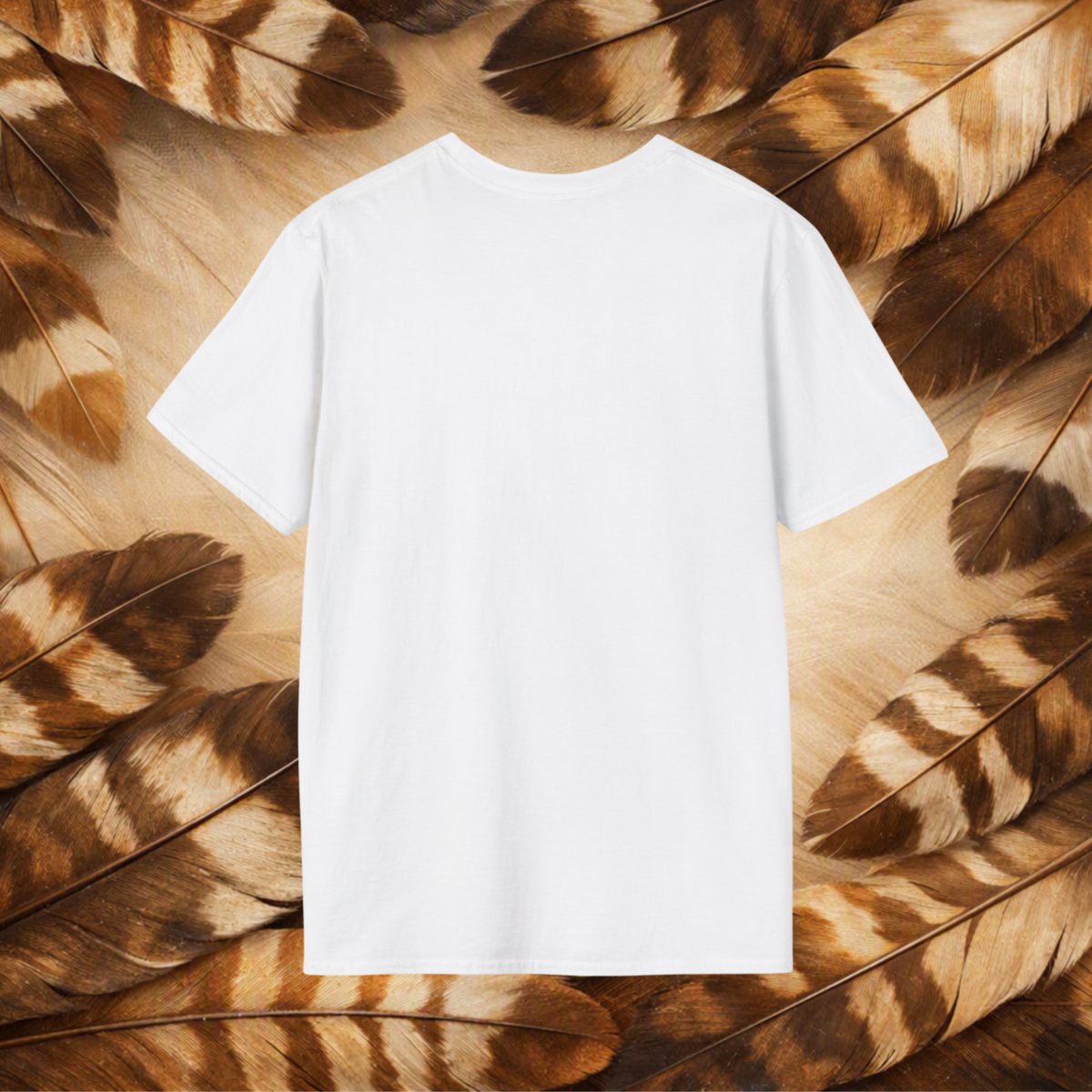 A plain white short-sleeve crewneck T-shirt laid flat, centered against a background of brown and tan feathers.