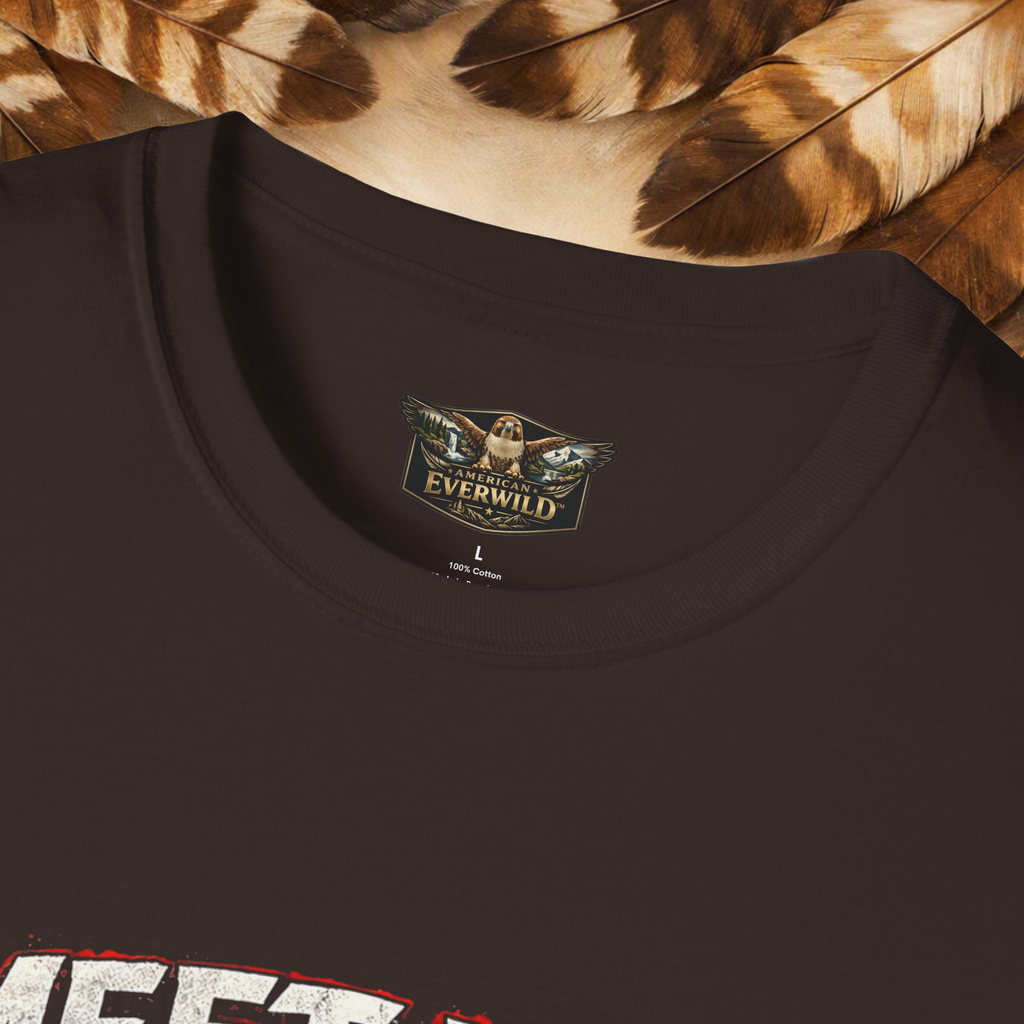 Close-up of a dark brown crewneck t-shirt featuring a printed neck label for 'American Everwild' with a hawk graphic and painted wings, styled with brown and beige feathers at the top.