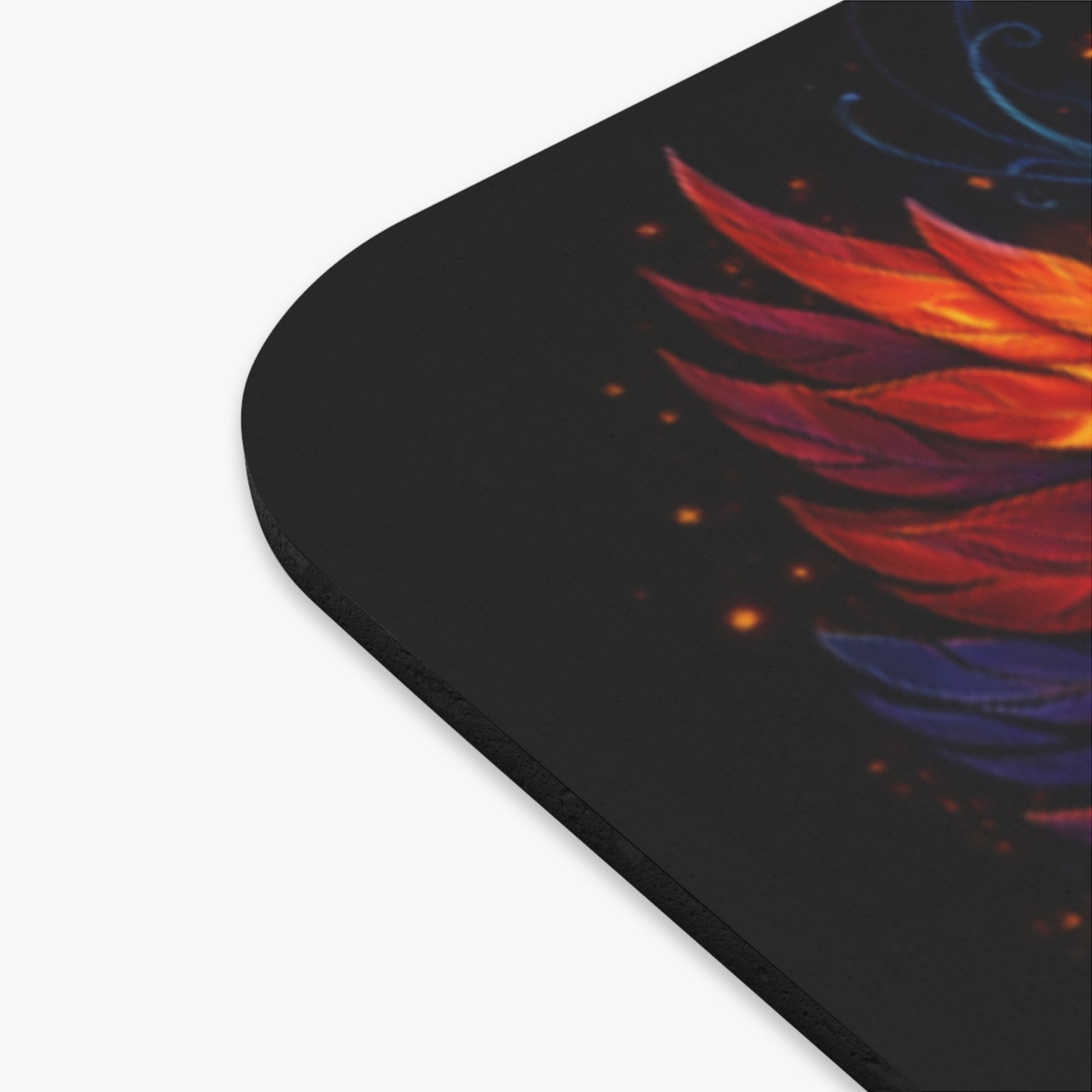 Corner close-up of dark mouse pad with red and blue wing graphic