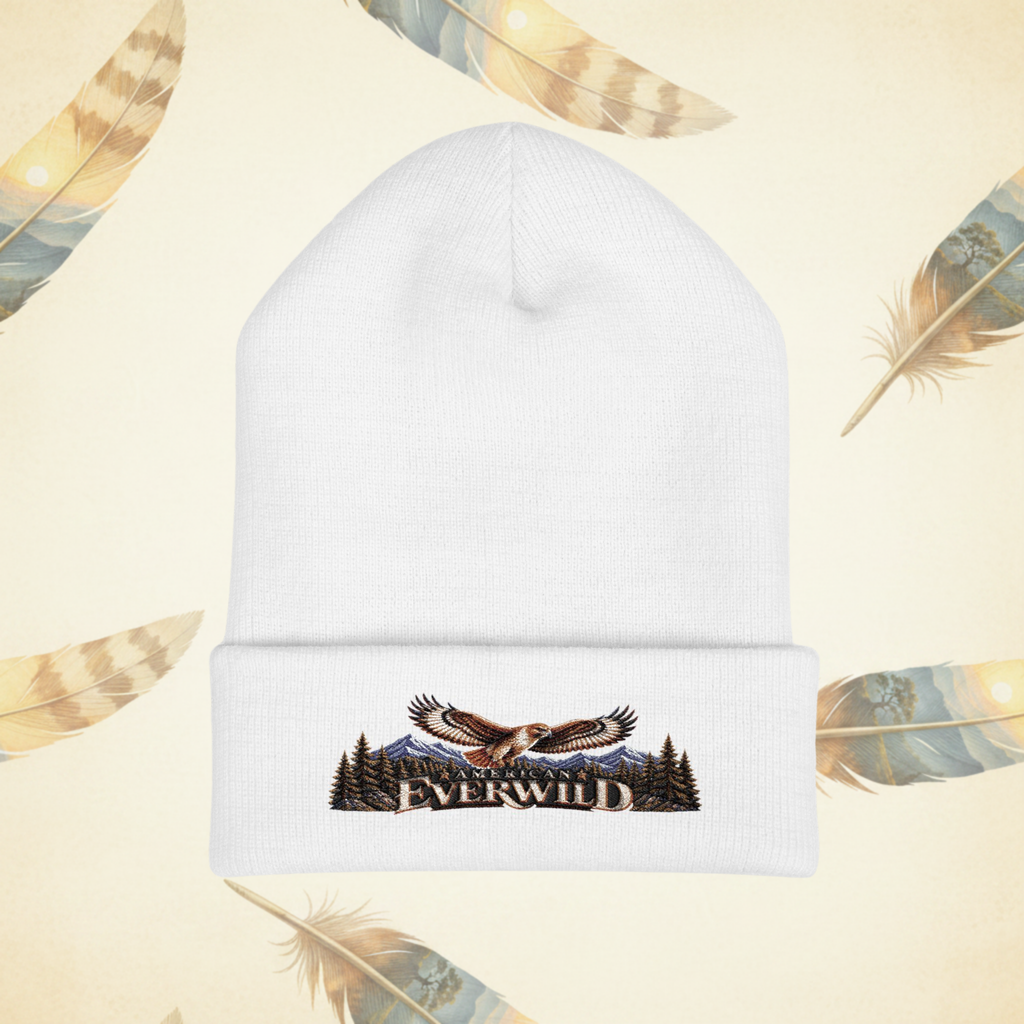 Wihite American EverWild Beanie flat-lay on a cream-colored background of painted feathers.