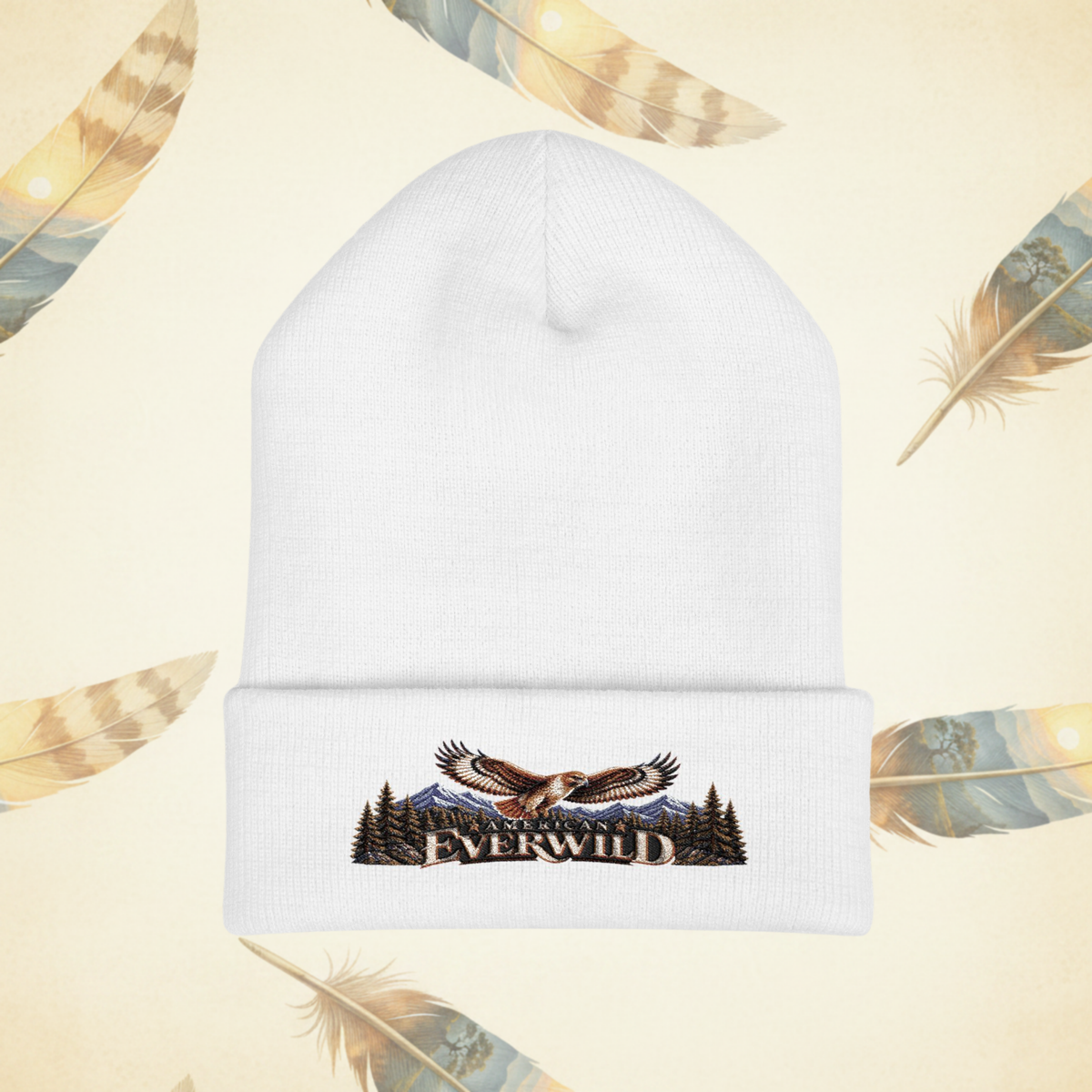 Wihite American EverWild Beanie flat-lay on a cream-colored background of painted feathers.