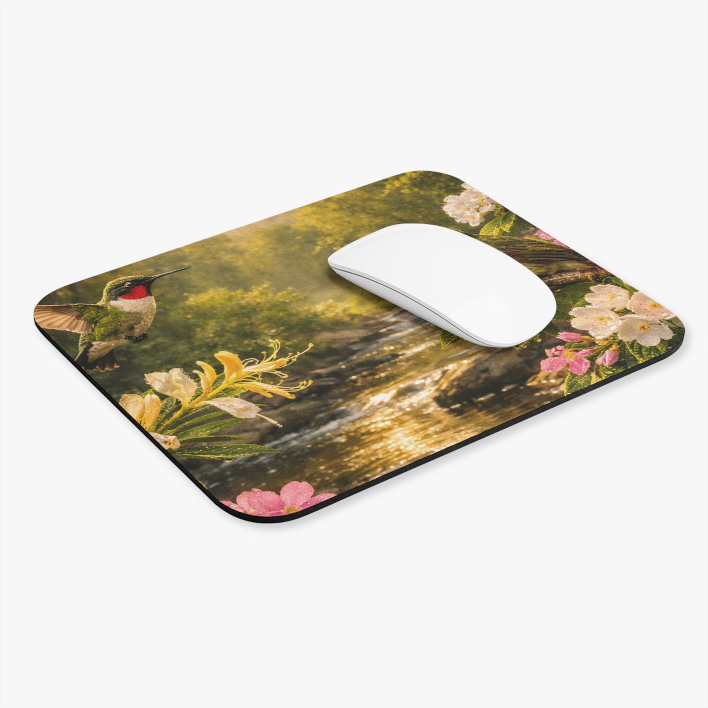 Rectangular mouse pad with hummingbirds over a river and colorful flowers; white mouse