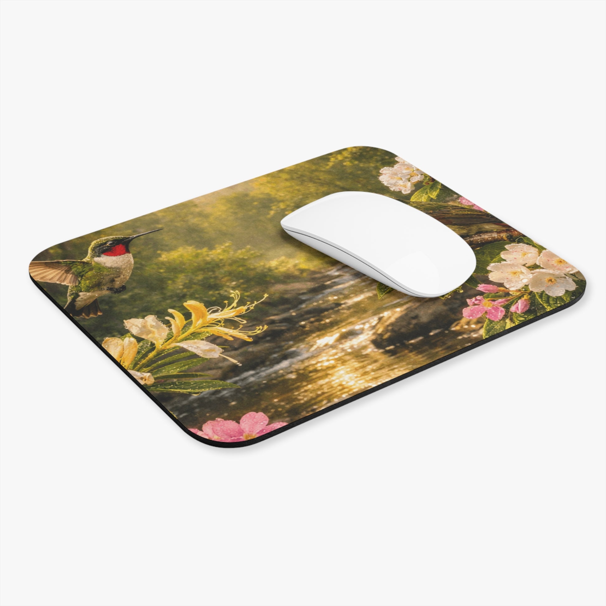 Rectangular mouse pad with hummingbirds over a river and colorful flowers; white mouse