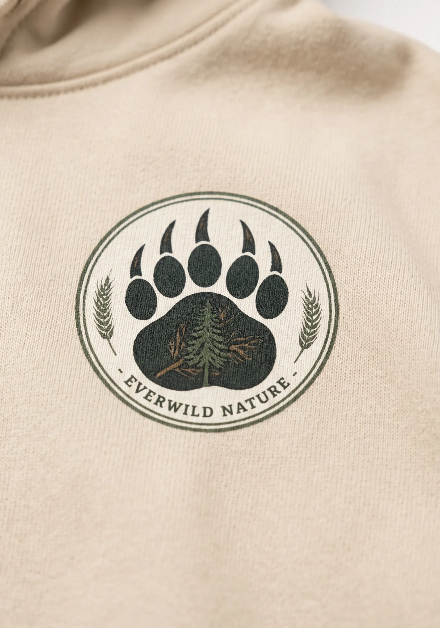 Beige hoodie chest patch graphic with paw prints and “EVERWILD NATURE” text
