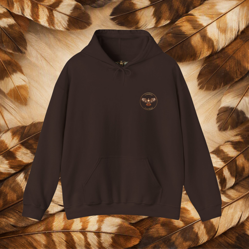 A chocolate brown pullover hoodie with a small circular hawk graphic on the left chest with the text "American Everwild." Displayed against a background of brown and beige feathers.