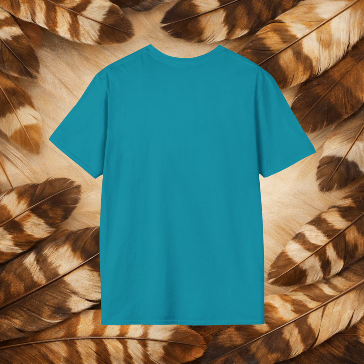 A tropical blue short-sleeve t-shirt displayed flat against a background of tanand brown patterned feathers.