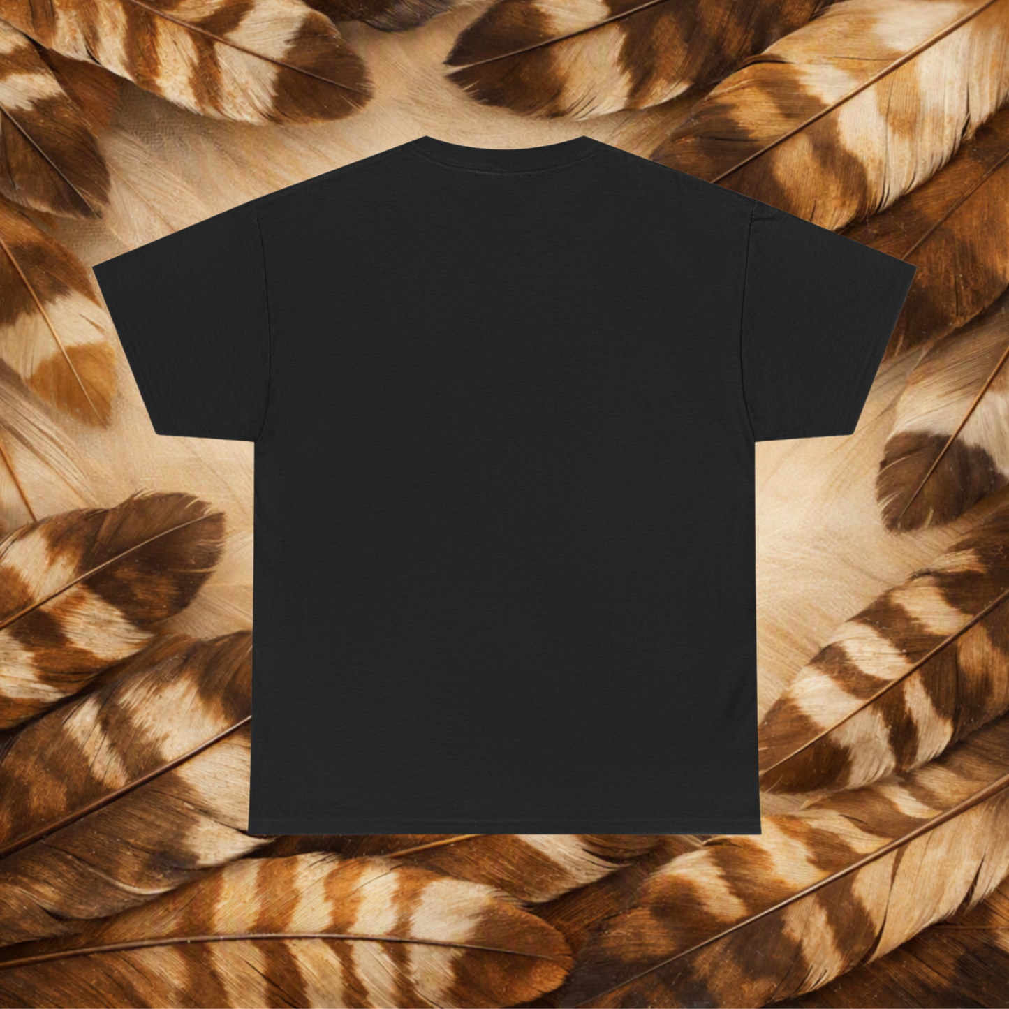 A plain black short-sleeve T-shirt laid flat against a background of Hawk feathers.