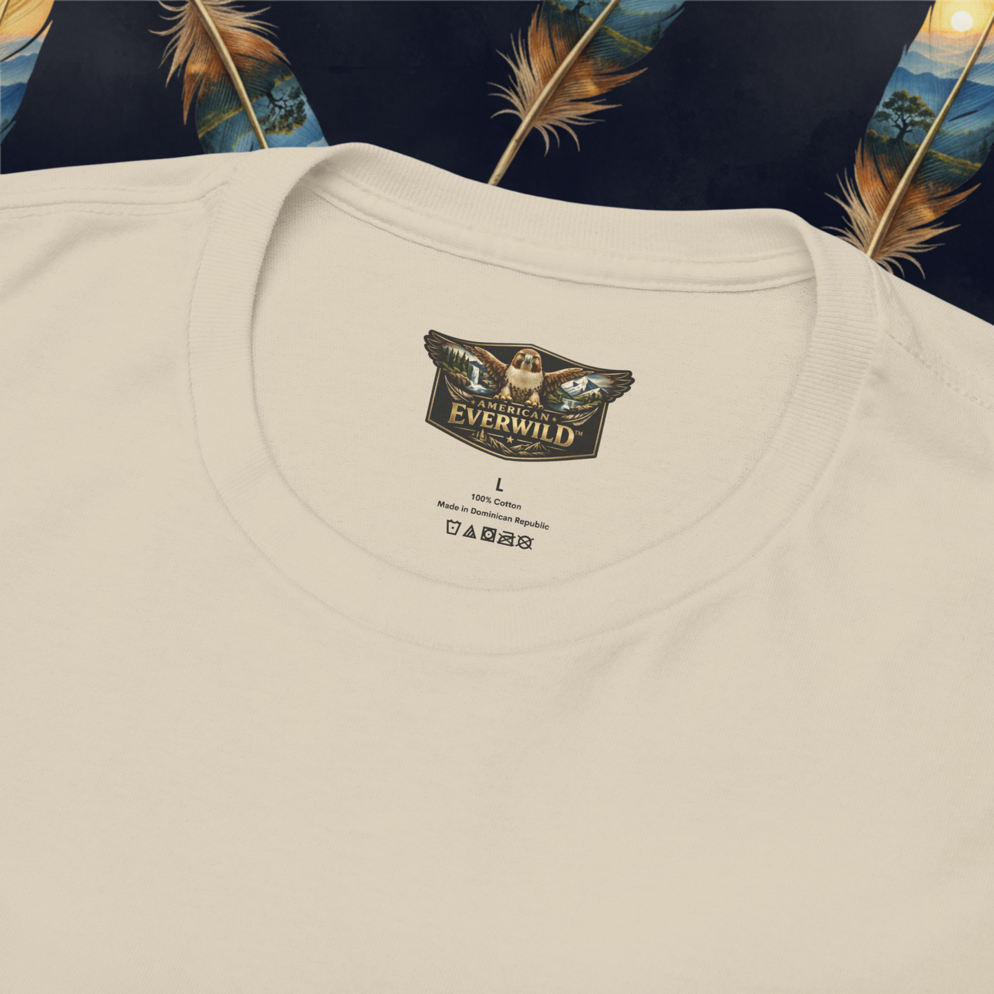 Close-up of a sand-colored crewneck t-shirt laid flat, showing the inner neck label with the brand 'American Everwild'.