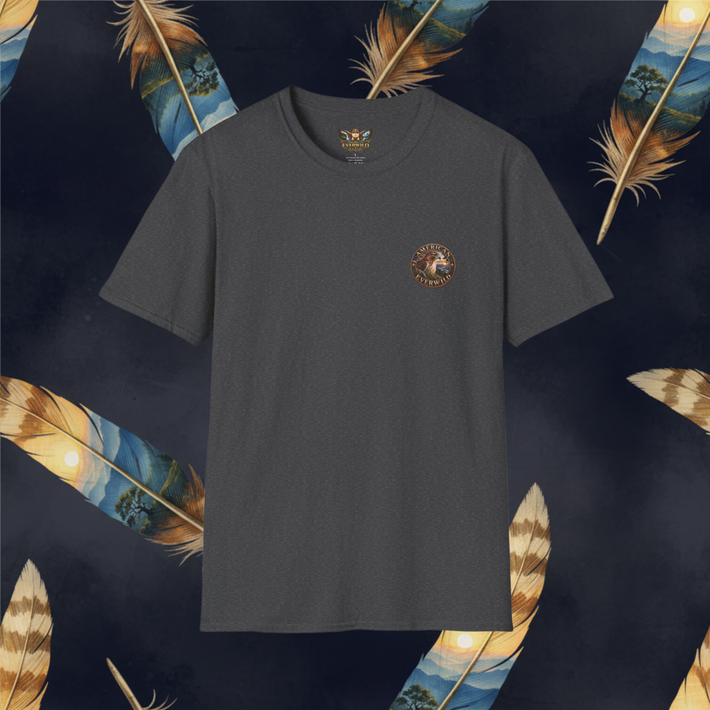 A dark charcoal gray crewneck t-shirt with a small circular graphic on the left chest, displayed against a dark navy background decorated with large golden-brown feathers.