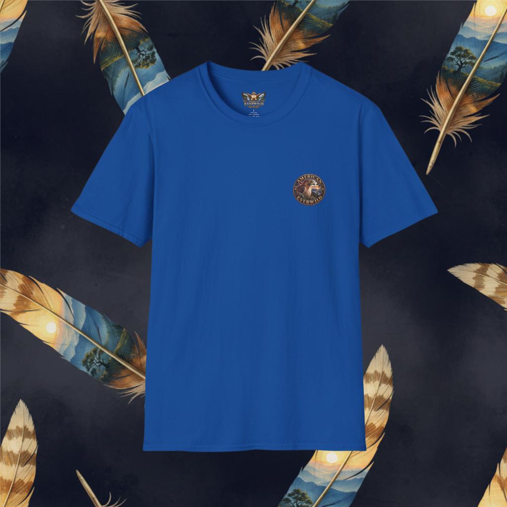 A royal blue short-sleeve crewneck t-shirt with a small circular embroidered logo on the left chest, displayed against a dark background decorated with large golden-brown feathers.