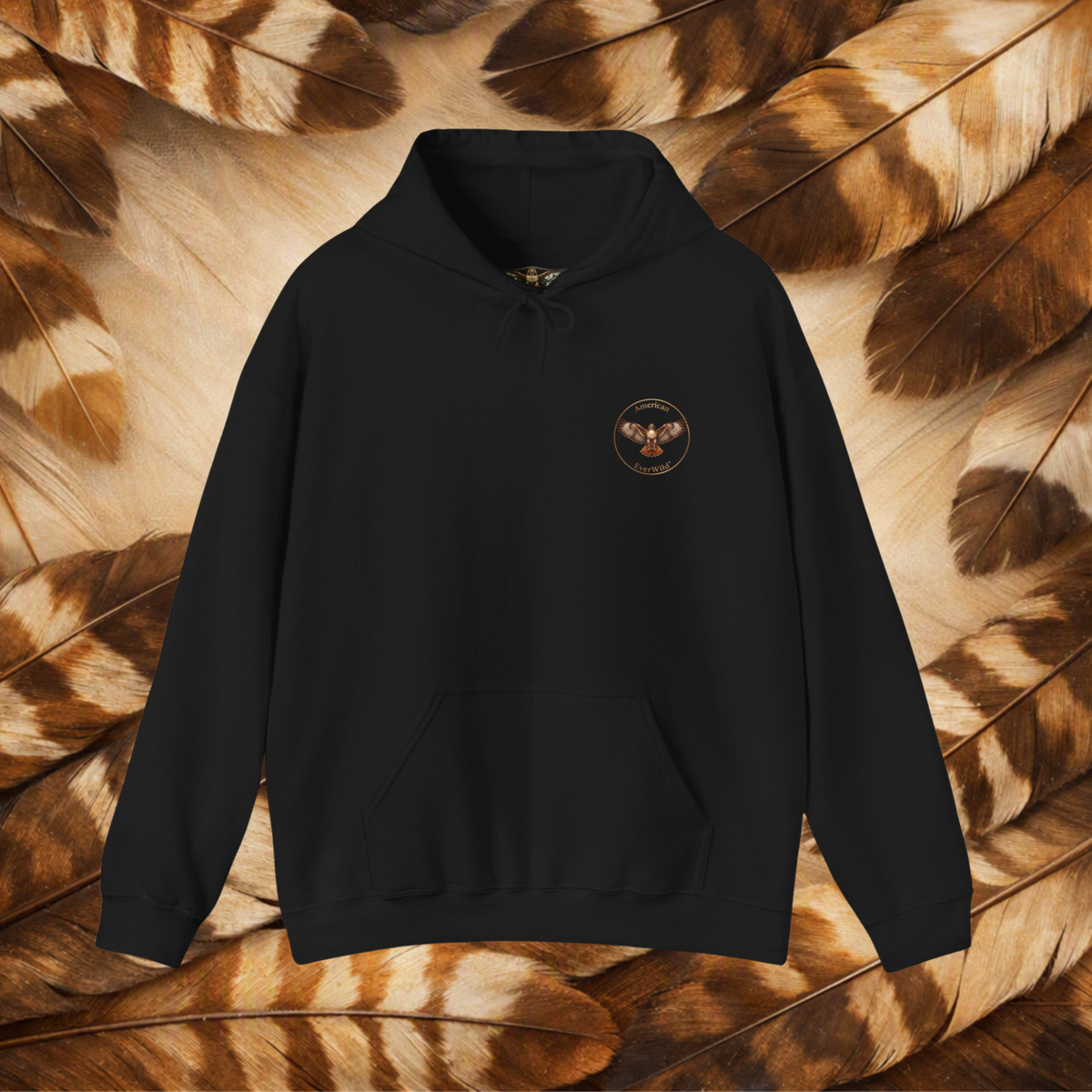 A black pullover hoodie with a small circular graphic on the left chest for American EverWild, displayed against a background of brown and beige feathers.