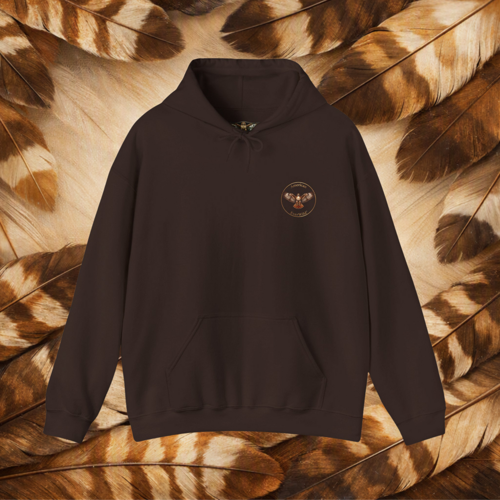 A chocolate brown pullover hoodie with a small circular graphic on the left chest featuring a red-tailed hawk and American EverWild text, displayed against a background of brown and beige feathers.