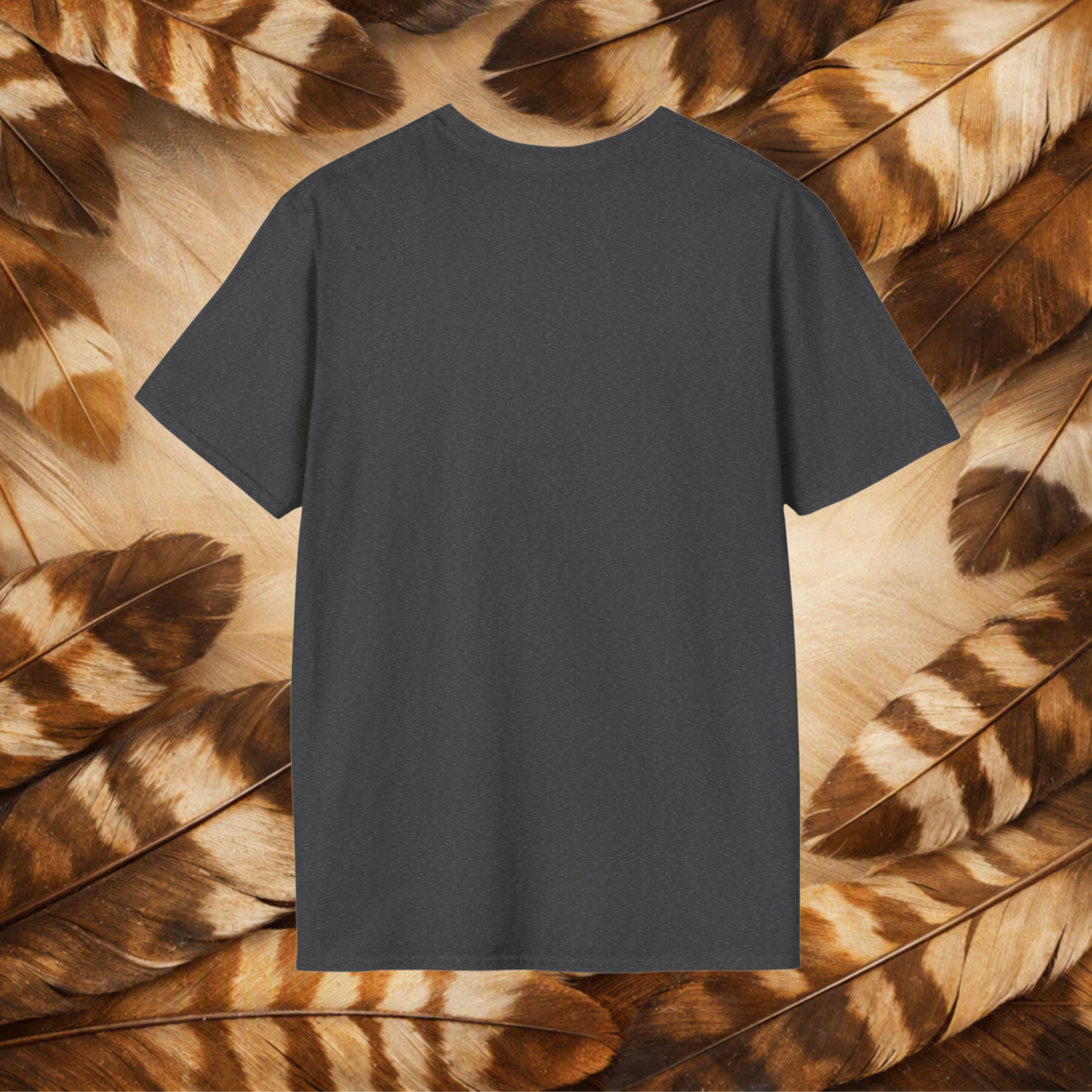 A dark charcoal gray short-sleeve t-shirt is centered against a background of brown and beige feathers.