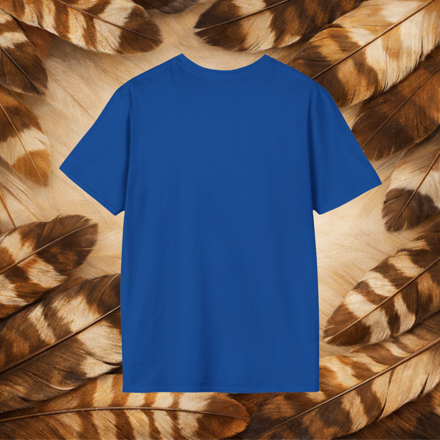 A solid royal blue short-sleeve t-shirt displayed flat against a background of brown and beige feathers.