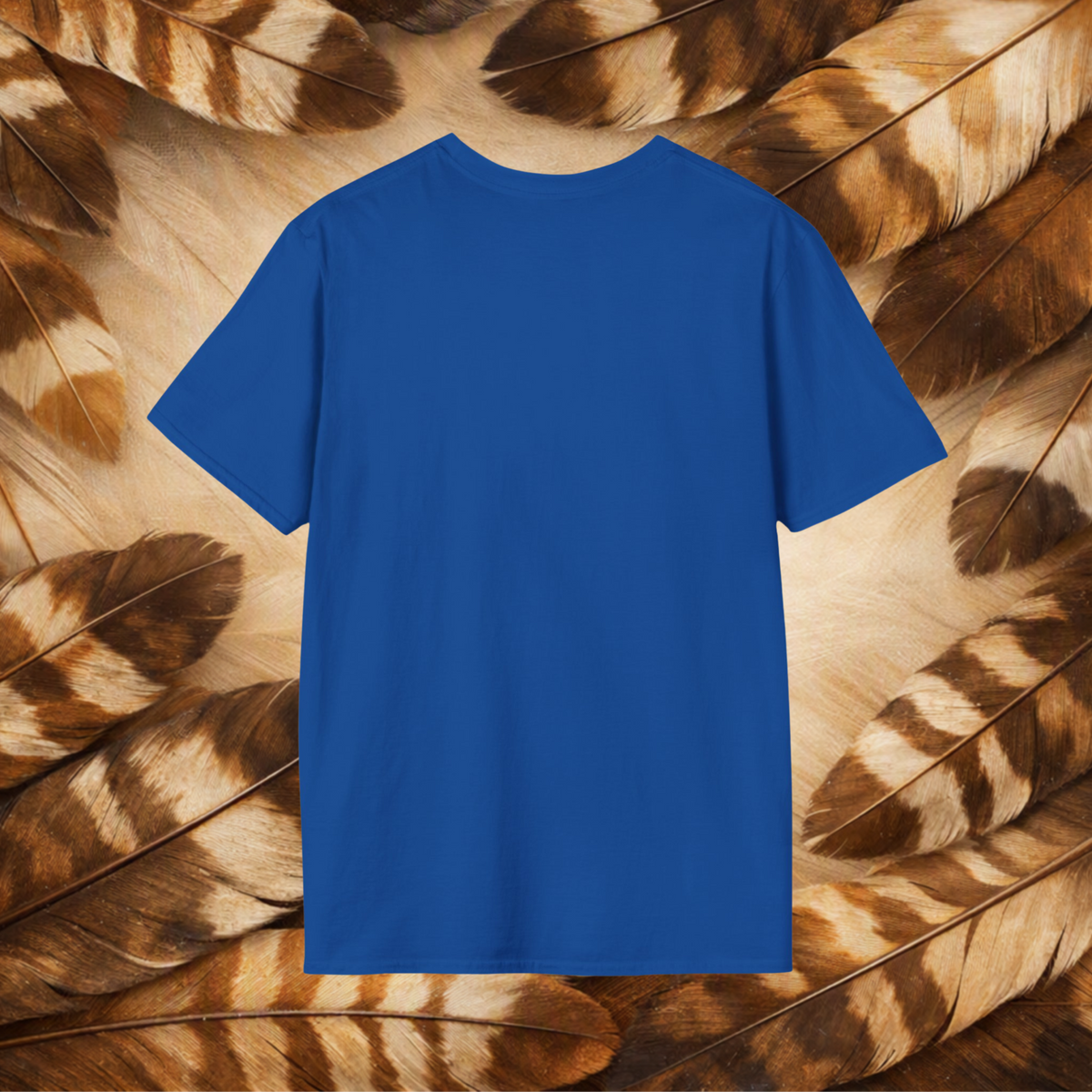 A solid royal blue short-sleeve t-shirt displayed flat against a background of brown and beige feathers.