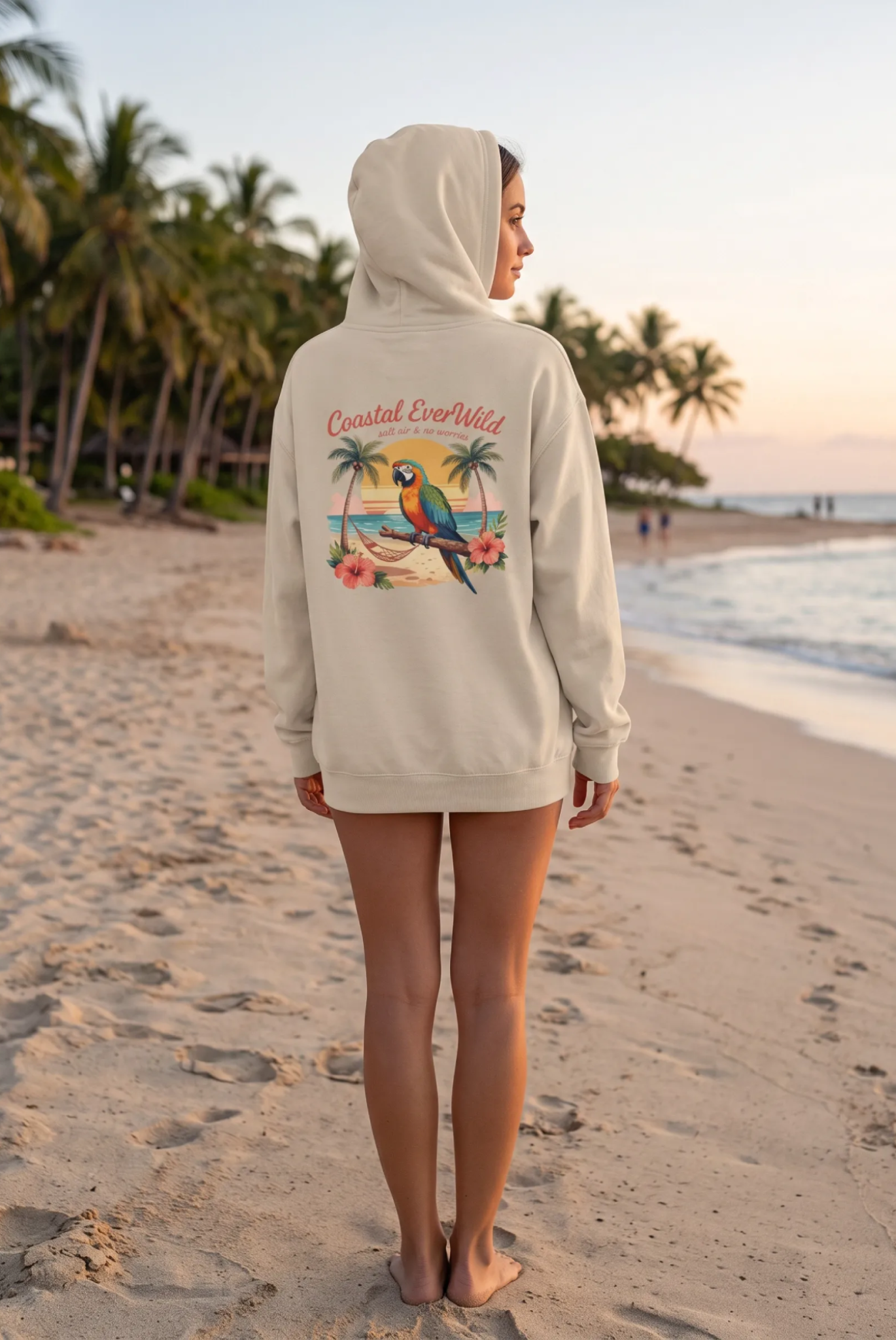 Cream coastal hoodie with hood and kangaroo pocket, back view with colorful beach graphic