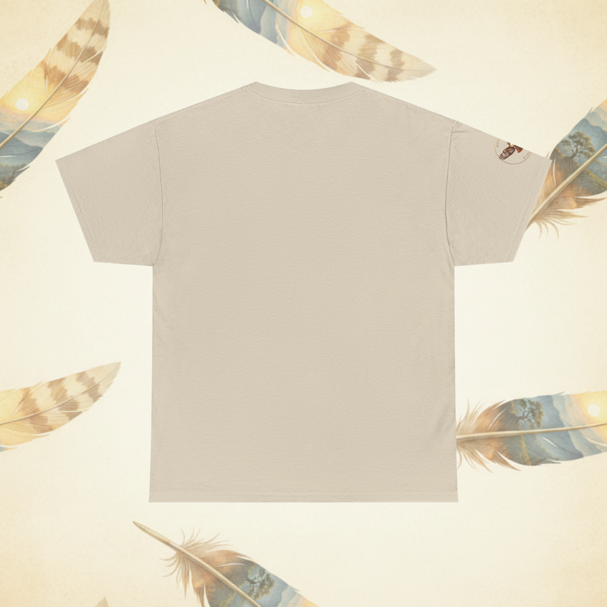 A flat-lay view of the back of asand colored crewneck t-shirt, shown against a cream-colored background decorated with scattered feathers.