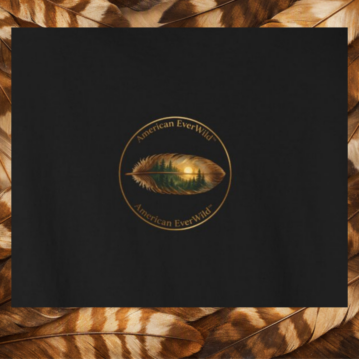 A black square close up of the back print, featuring a circular gold logo with a central feather design that reflects a forest landscape. The text 'American EverWild' is written along the top and bottom of the circle.