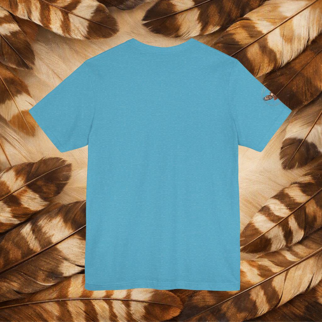 A blue tee shown from the back, the tee is laid flat on a background composed of brown and tan feathers.