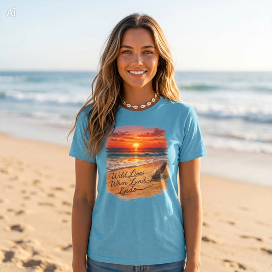 Teal T-shirt with centered sunset ocean graphic and 'Wild Lives Where Land Ends' text