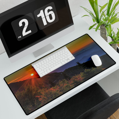 Extended desk mat with sunrise mountain photo print on white desk; black trim